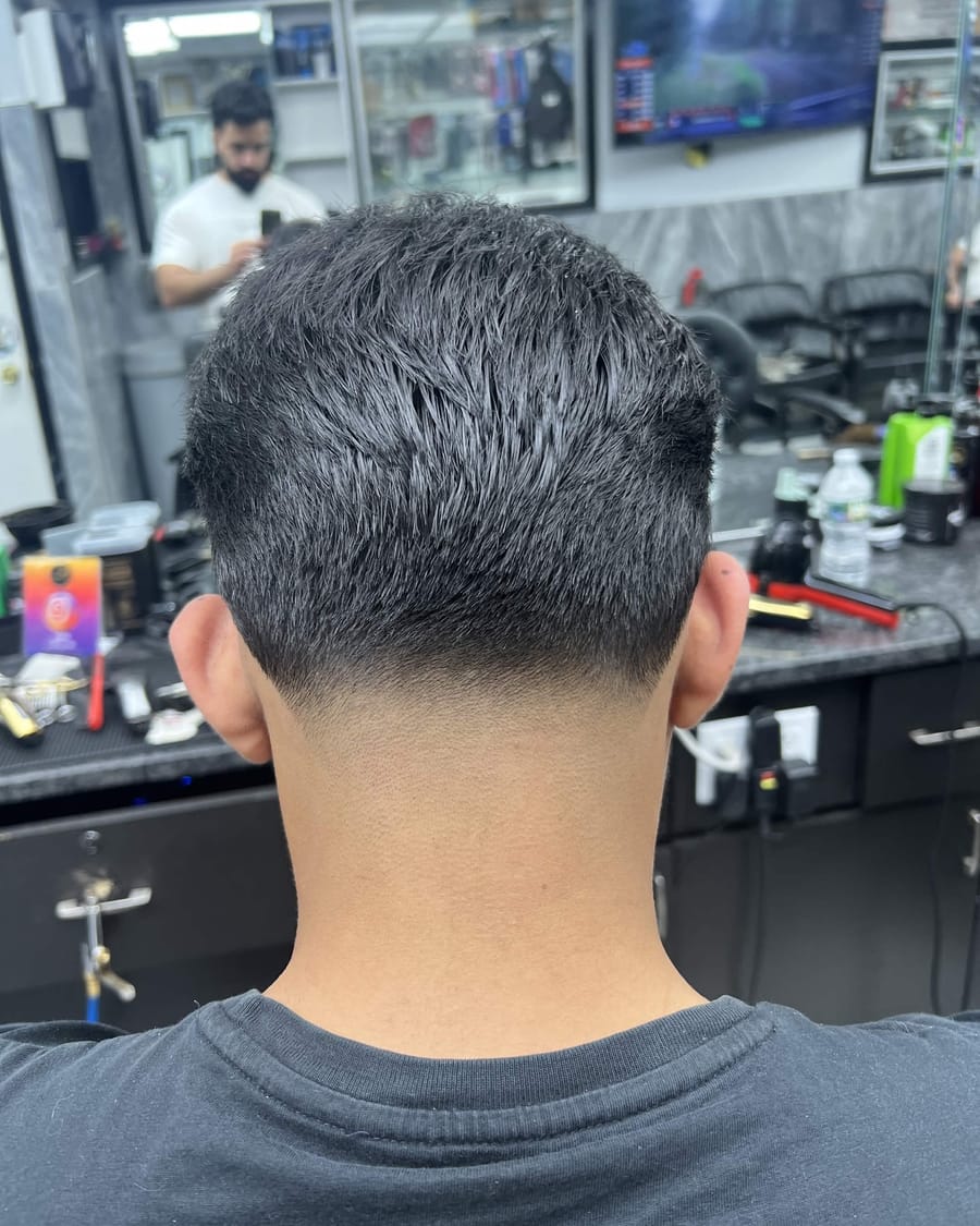 A finished fade — the back of a fresh cut at the chair.